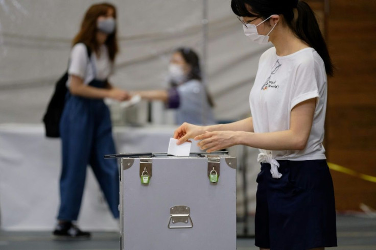 Voters in Tokyo were urged to use hand sanitiser after casting their ballot