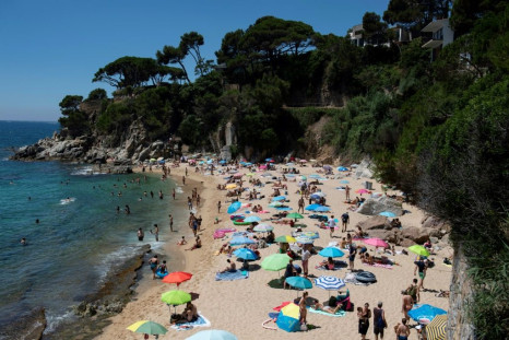 People enjoy a day out at the beach in Platja D'Aro near Girona -- Spaniards endured one of the world's toughest lockdowns for three months from March 2020