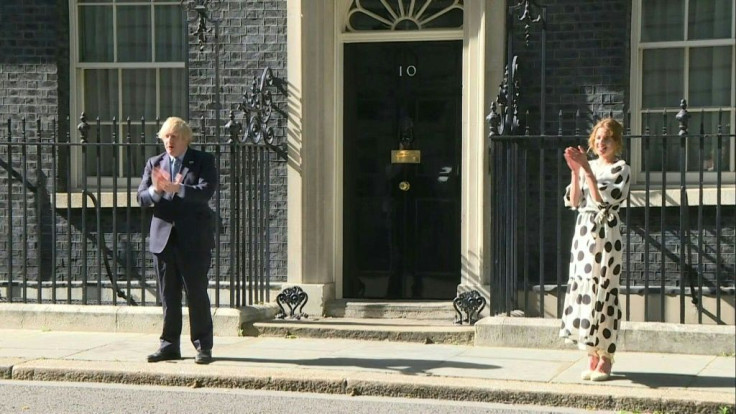 British Prime minister Boris Johnson and "Clap for Carers" founder Annemarie Plas clap for the NHS outside 10 Downing street