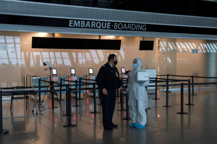 A health worker carries swabs taken from passengers of an Iberia flight to be tested on arrival at Carrasco International Airport, Uruguay