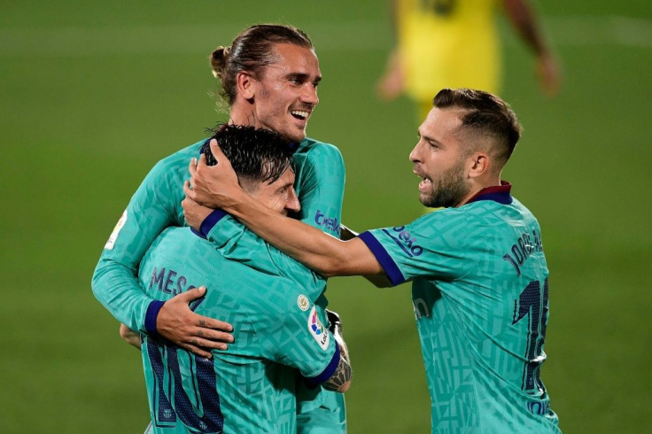 Antoine Griezmann celebrates with Lionel Messi after scoring a sensational chip against Villarreal on Sunday.