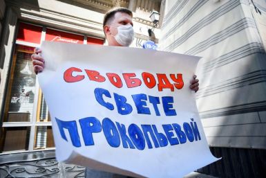 An activist demands 'Freedom for Svetlana' as a Russian court finds journalist Svetlana Prokopyeva guilty of 'justifying terrorism'