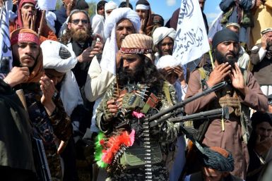 Afghan Taliban militants and villagers celebrating the deal with the US in March 2020