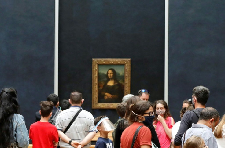 Visitors wearing face masks queue to view Leonardo da Vinci's "Mona Lisa" masterpiece as the museum seeks to start recouping millions of lockdown losses