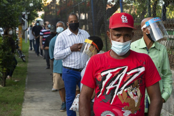 People line up to vote at a polling station in the Dominican Republic capital Santo Domingo on July 5, 2020