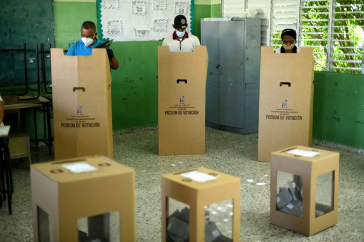 People vote at a polling station during presidential and legislative elections in Santo Domingo, on July 5, 2020
