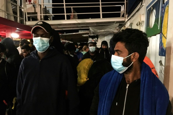 Police escorted the migrants a short distance to another ship, where they will be quarantined to prevent the possible spread of coronavirus