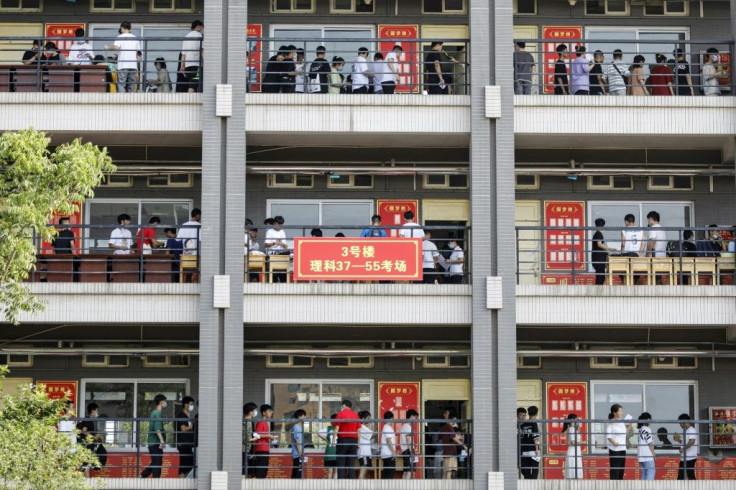 Students queue outside examination rooms on the first day of Gaokao