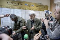 Russian historian Yury Dmitriyev (pictured April 2018), who heads rights group Memorial's branch in Karelia, speaks to the media as he leaves a court following the verdict in his child pornography trial in the northwestern city of Petrozavodsk