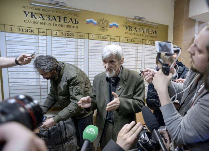 Russian historian Yury Dmitriyev (pictured April 2018), who heads rights group Memorial's branch in Karelia, speaks to the media as he leaves a court following the verdict in his child pornography trial in the northwestern city of Petrozavodsk