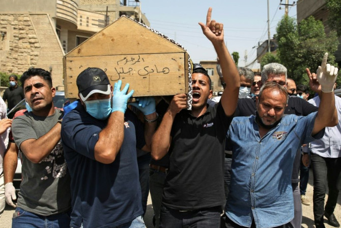 Mourners carry the coffin of Iraqi jihadism expert Hisham al-Hashemi, who was shot dead outside his house in the Iraqi capital
