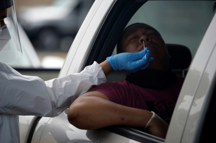A health care worker administers a COVID-19 test at United Memorial Medical Center testing site in Houston, Texas -- now only the third state to register more than 10,000 virus cases in a 24-hour period