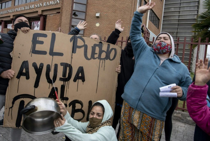 Women bang pots next to a sign reading âThe people helps the peopleâ to protest not getting aid during the coronavirus lockdown; the UN warns that 45 million people in Latin America and the Caribbean could fall into poverty because of the pandemic