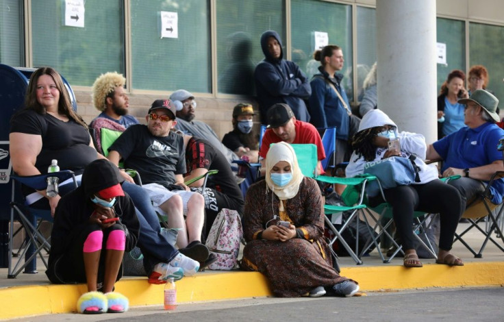 Hundreds of unemployed Kentucky residents wait in line outside the Kentucky Career Center in mid-June 2020 for help with their unemployment claims in Frankfort
