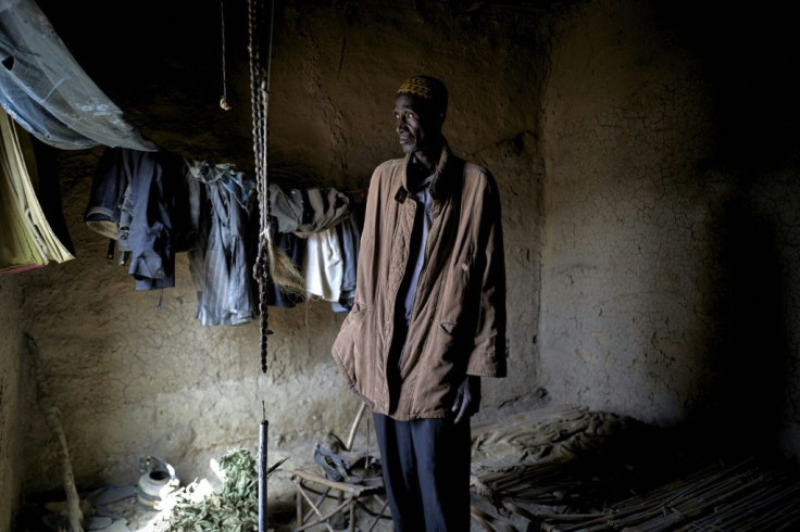 Boubou Sangare stands in the house of his brother, a former soldier who was brutally murdered