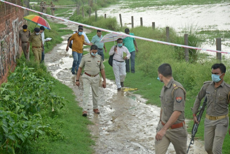 Police arrive at the scene to investigate after the shooting of Dubey