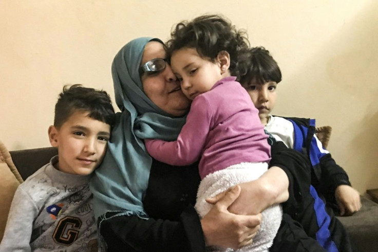 Taheyya is pictured with her other grandchildren, whose cousins are stuck in Syria. 'I have never been able to hug them,' she says