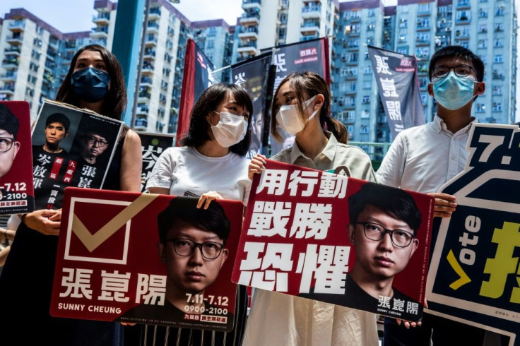Joshua Wong (R) and fellow pro-democracy activists campaign during the primary which was held despite a warning that it could be in breach of a tough new security law imposed by Beijing