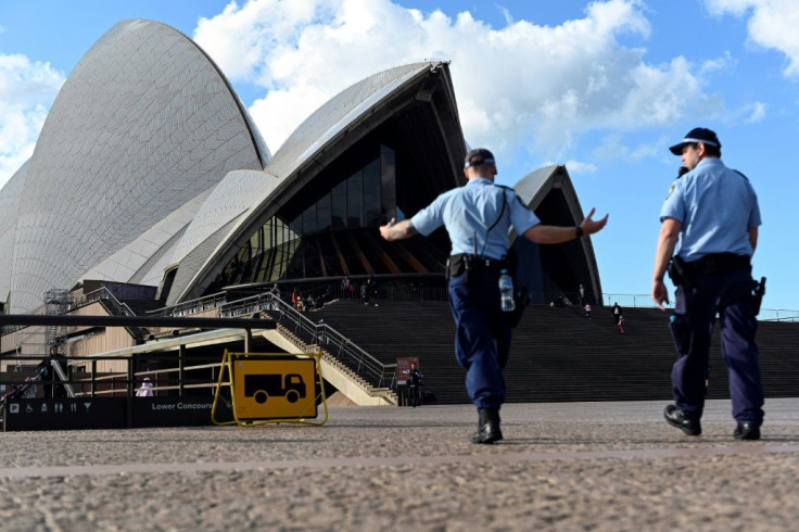 Police patrol near the Sydney Opera House, an area usually thronged with tourists, during Australia's coronavirus outbreak