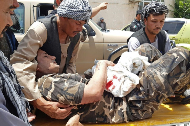A wounded security staffer is carried by  stretcher to hospital after the Aybak car bomb