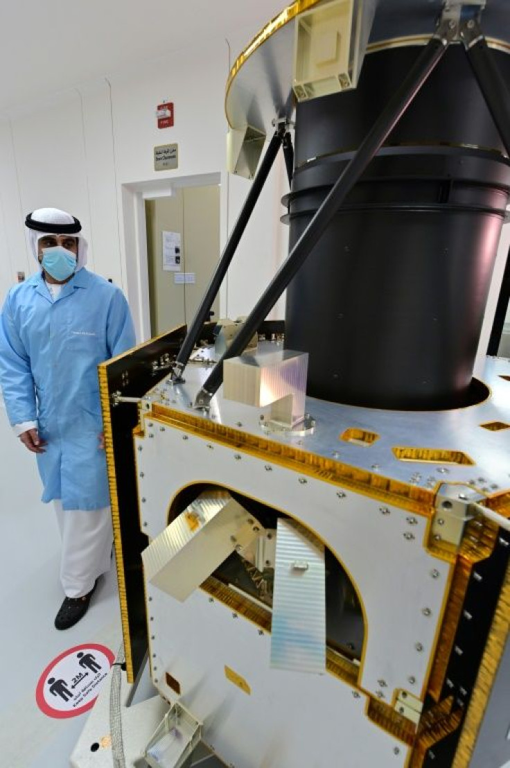 An engineer observes a model of a previous UAE space project, the satellite KhalifaSat