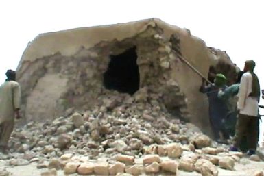 A still from a video shows jihadists destroying an ancient shrine in Timbuktu in 2012