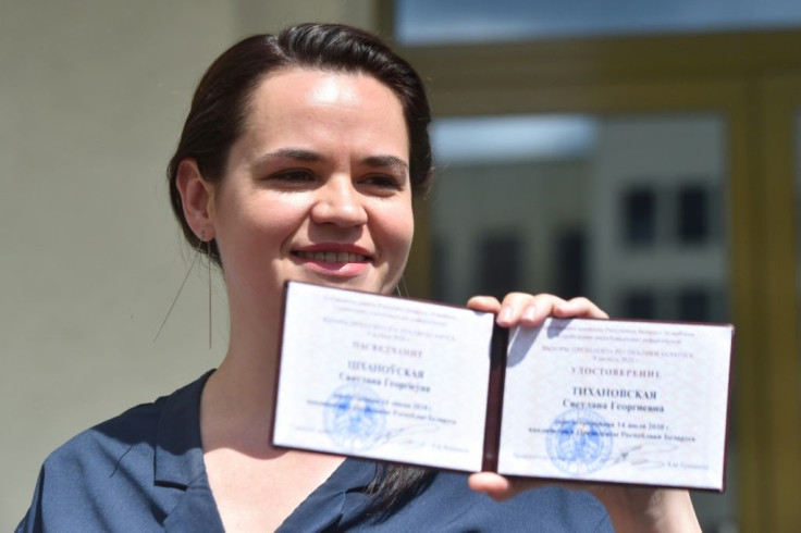 Svetlana Tikhanovskaya, the wife of a jailed vlogger running in his place, shows her certification to run for president