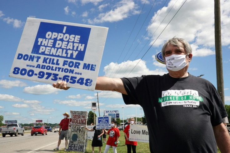 Opponents of the death penalty protest near the Federal Correctional Complex in Terre Haute, Indiana, where Daniel Lewis Lee was executed