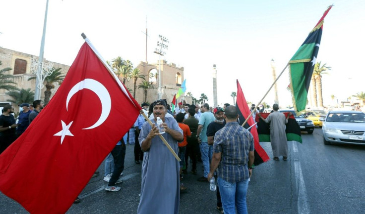 People wave flags of Libya (R) and Turkey (L) during a demonstration in Tripoli