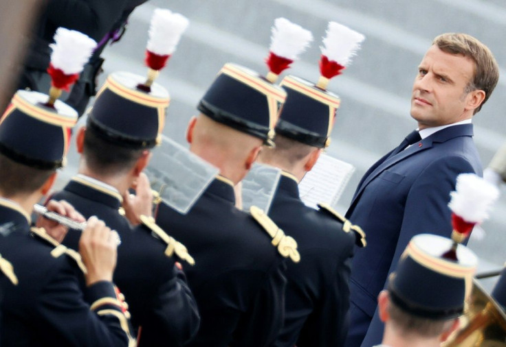 French President Emmanuel Macron reviews the guard of honour during the annual Bastille Day military ceremony in Paris