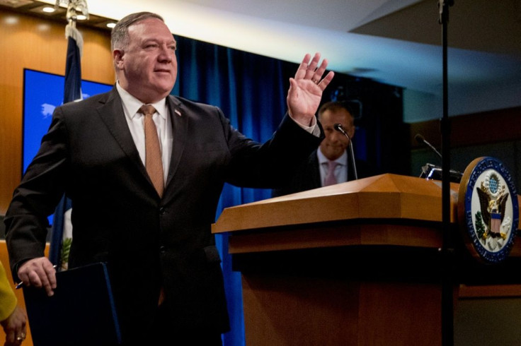 Secretary of State Mike Pompeo waves as he leaves a news conference in which he announced new action against Chinese telecom giant Huawei