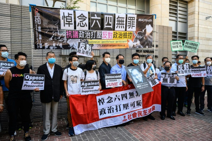Hong Kongers including millionaire media tycoon Jimmy Lai (third from left) gather outside a court where activists are facing charges for holding an unauthorized commemoration of the 1989 crackdown in Tiananmen Square