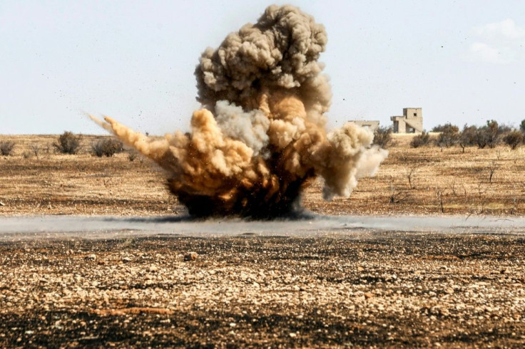 A landmine is remotely detonated in a field at a pistachio orchard in the village of Maan