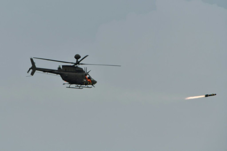 A US-made OH-58D Kiowa helicopter fires a Hellfire anti-armour missile