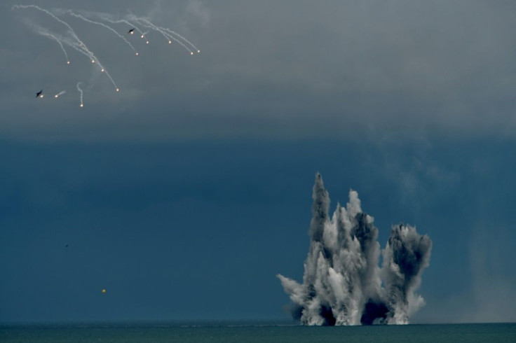 Two US-made F-16V fighter aircraft release flares after dropping bombs during the biggest military exercise of the year