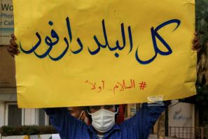 Peace demand: A demonstrator in Khartoum on July 4 holds up a sign reading 'All of the country is Darfur - #PeaceFirst'