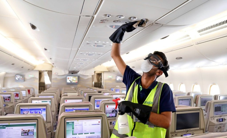 A member of the cleaning staff disinfects air vents aboard an Emirates plane; the company Medistar says its new air filtration system based on heated nickel foam can be placed inside air conditioning systems or walked through a plane via a mobile unit