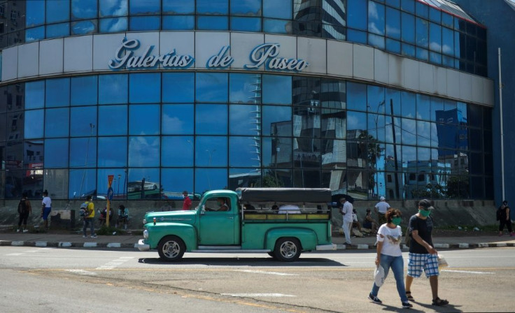 A group of people gather outside of a mall in Havana July 16, 2020 during the coronavirus pandemic