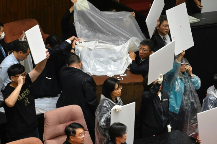 DPP legislators donned plastic raincoats and used cardboard shields to protect themselves from the water balloons