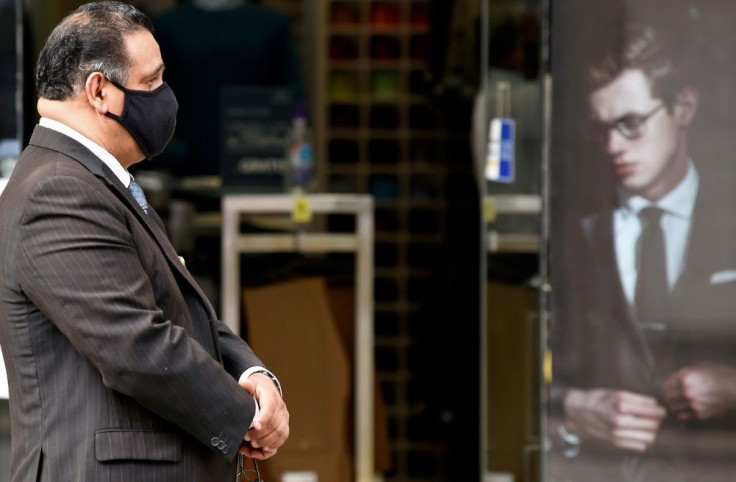 The manager of a men's clothing store waits for customers in Mexico City, on July 16, 2020