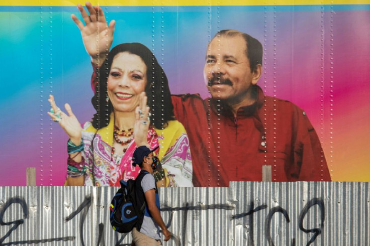A man in Managua walks in April 2020 by a mobile health clinic displaying a picture of Nicaragua's President Daniel Ortega and his wife, Vice President Rosario Murillo, whose son Juan Carlos Trujillo has been hit by US sanctions