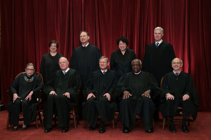 The current members of the US Supreme Court pose for a group photo with Justice Ruth Bader Ginsburg on the bottom left