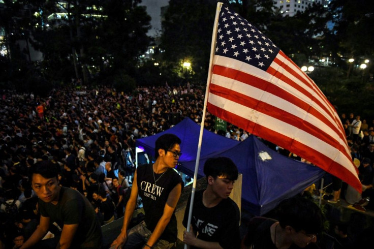 Hong Kongers opposed to an extradition bill with mainland China hold an American flag at an August 2019 protest
