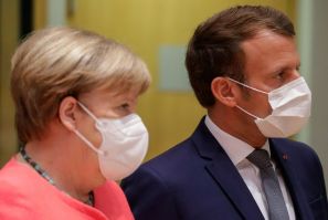 Germany's Chancellor Angela Merkel (L) and France's President Emmanuel Macron were described as looking annoyed after they left a late night meeting with the Netherlands' Prime Minister Charles Rutte