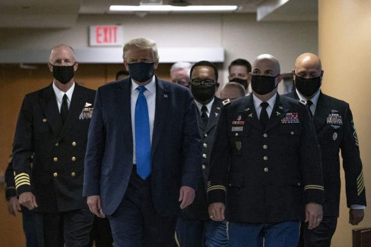 US President Donald Trump, seen wearing a mask for the first time in public during a visit to a military hospital near Washington, continues to oppose a national mask mandate