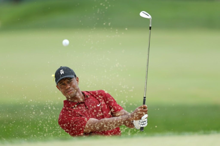 Tiger Woods blasts out of a bunker on the way to a double-bogey at the seventh hole in the final round of the US PGA Tour Memorial tournament
