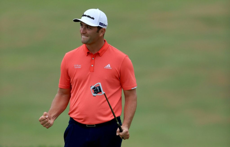 Spain's Jon Rahm celebrates on the 18th green after winning the US PGA Tour Memorial to grab golf's number one world ranking