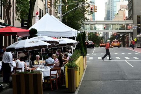 People dining outside a restaurant in Manhattan as New York tries to get back its famous energy after the COVID crisis