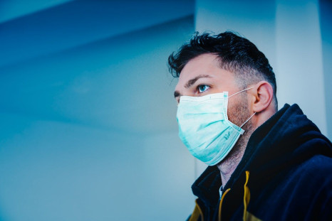 man-in-black-and-yellow-jacket-with-face-mask-3991782