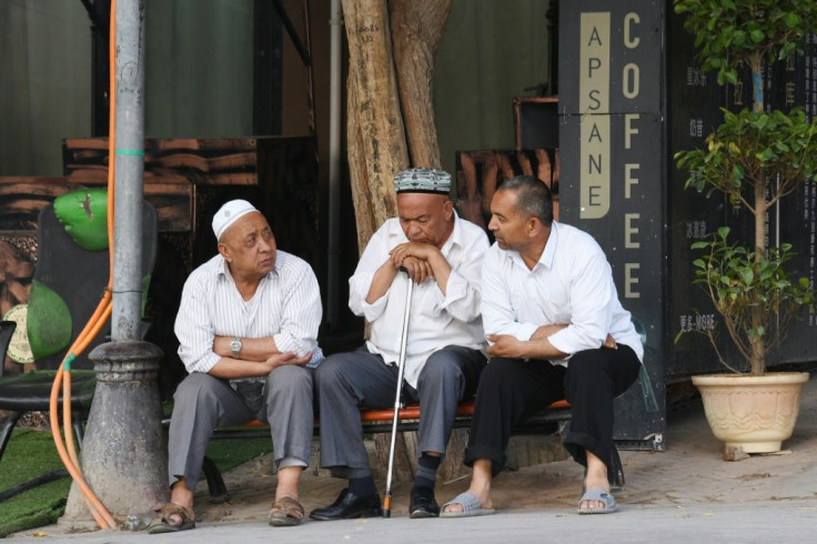 Uighur men resing in front of a coffee bar in Kashgar, western Xinjiang. China denies abusing the Uighur  population and says such accusations are slander